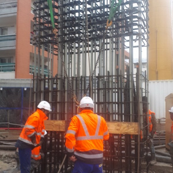 Four construction workers working on the Grand Paris Express construction site