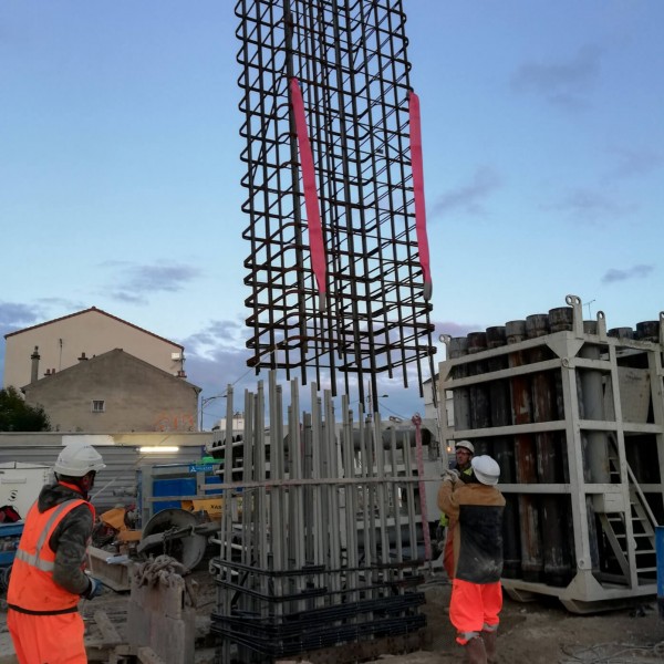 Three workers working on building the Grand Paris Express