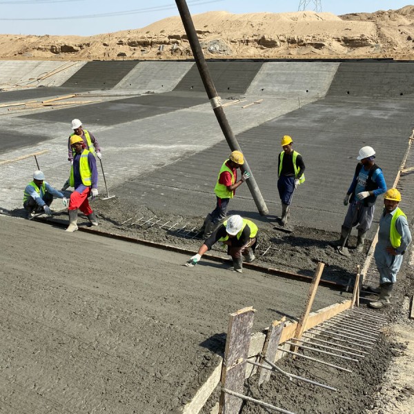 Eight construction workers working on the Jizan Flood Mitigation Channel project