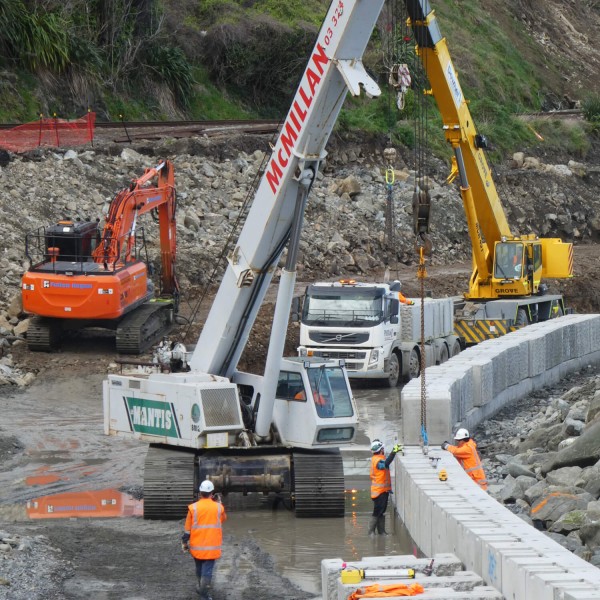 Workers on the State Highway 1 job site with heavy machinery