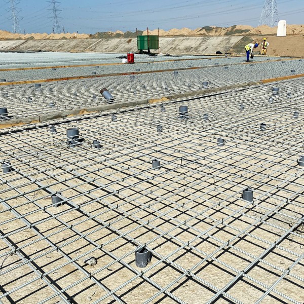 Two workers working on reinforcing with GFRP on the Jizan Flood Mitigation Channel job site.