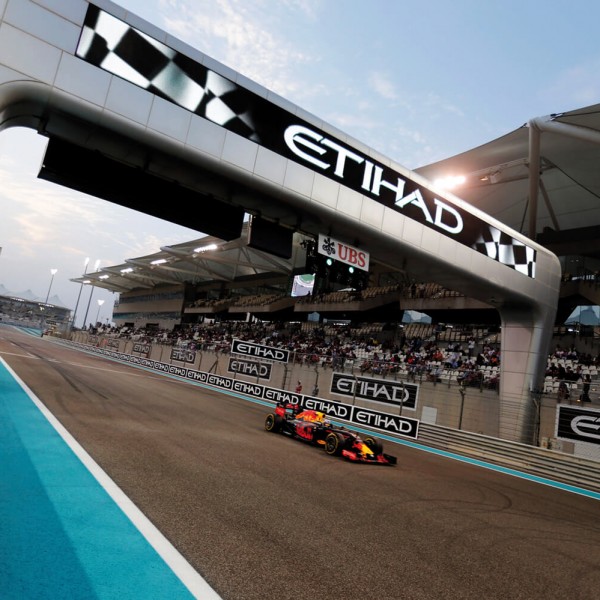 An F1 race car driving on the Yas Island F1 Racetrack.