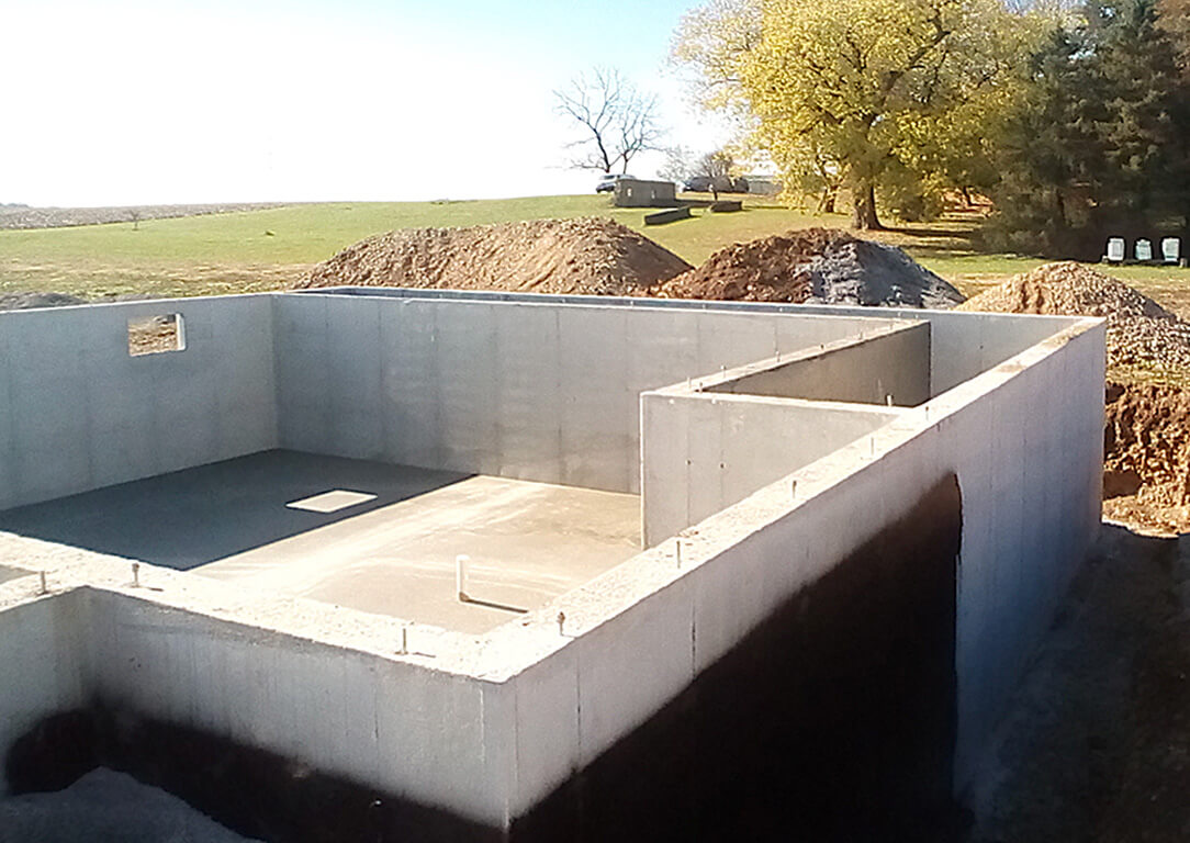 A half-built concrete structure next to piles of dirt