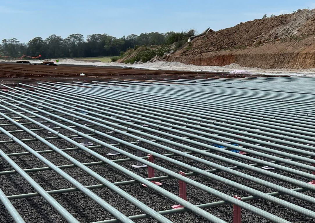 A close view of fiberglass rebar on a project near a dirt pile