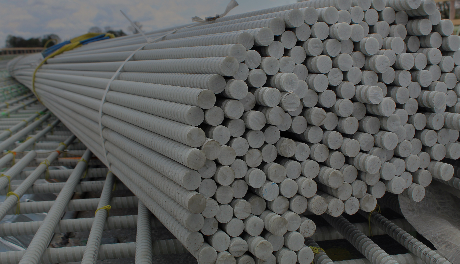 Bundles of grey fiberglass rebar tied up