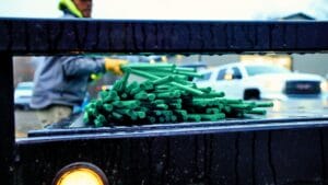 A man loading bundles of Greenbar2X fiberglass rebar onto a truck